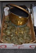 A brass coal helmet and a large quantity of horse brasses.
