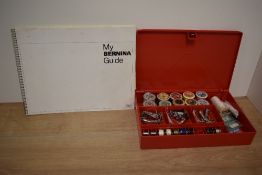 A tub of sewing threads and a guide