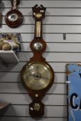 A large late 18c early 19c mahogany banjo barometer having integral convex mirror and boxwood