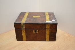 A Victorian mahogany writing slope, with brass banded design and opening out to a black tooled