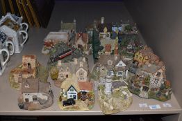 A selection of Lilliput Lane, Danbury Mint and similar model houses including Lundy Lighthouse and a