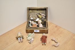 A collection of 19th Century miniature porcelain jointed dolls, to include two wooden peg dolls