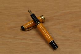 A boxed with papers Aurora Minima twist fill fountain pen in orange marble with gold trim having 18K