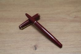 A Parker 17 aerometric fill fountain pen in red with gold trim. Needs bladder