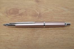 A Pilot Delicimo fountain pen in champagne having a Pilot 18k 750 F nib