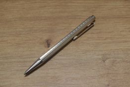 A Boxed Caran d'Ache Ecridor ballpoint pen, palladium coated with cheveron design. Engraved