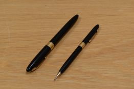 A Sheaffer Valiant snorkel fill fountain pen and propelling pencil set in black having Sheaffer