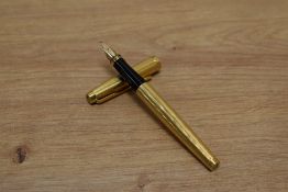 A Parker 75 converter fill fountain pen in gold plate in th Grain d'Orge design having Parker 585