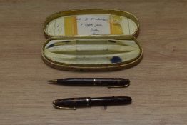 A boxed Conway Stewart lever fill Dinky 550 fountain pen and propelling pencil in gold red pink