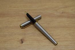 A Parker Arrow aerometric fountain pen in brushed steel with gold trim.