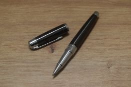 A boxed Nina Ricci rollerball pen. As new