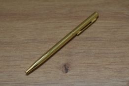 A boxed ballpoint pen made with crystallized Swarovski elements, in yellow metal