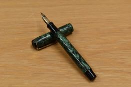 An Arnold button fill fountain pen in green swirl having 18ct rolled gold no.6 nib.