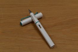 A Lamy Safari Special Edition cartridge fill fountain pen in white with green trim having M Lamy