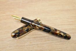 A Danitrio oversize converter fill fountain pen in Cumlaude brown and black marble having a B nib