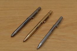 Three multi-coloured mechanical pencils. Two Norma, one in 14ct gold fill the other in chrome and