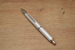 A boxed Pilot Decimo Capless vacuum fill fountain pen in pearl white having a Pilot 18K 750 nib.