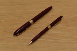 A Sheaffer Valiant Snorkel fill fountain pen and propelling pencil in burgundy having Sheaffer