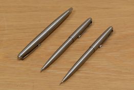 A Parker 45 converter fill fountain pen, ballpoint pen and propelling pencil set in brushed steel.