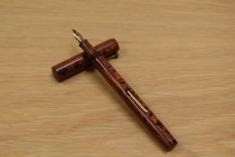 A Typhoo Tea lever fill fountain pen in red ripple hard rubber having warranted 14ct nib.