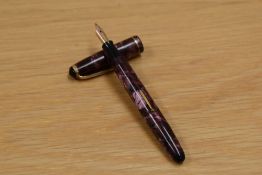 A DeLaRu Junior lever fill fountain pen in pink marble with single band to the cap having DeLaRu