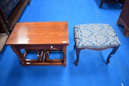 A modern oak nesting set of tables and a dressing table stool, table width approx 62cm.