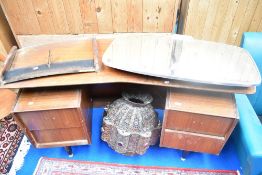 A vintage teak dressing table of curved form in the G plan style