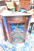 A 19th Century mahogany cupboard having glazed door