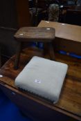 A traditional four legged milking style stool and a modern footstool