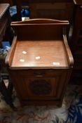 A late 19th / early 20th century oak coal purdonium, having carved panel to front.