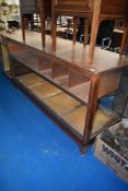 A vintage shop counter having glazed front and side, approx dimensions W241 D63 H94