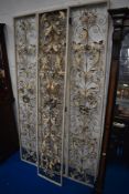 A modern mid century style room divider with three dimensional metal foliate decoration.