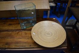A decorative shallow bamboo style fruit bowl and a glass terrarium style vase