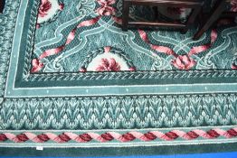 A vintage carpet square, having green ground with pink swag and flower decoration, approx 275 x