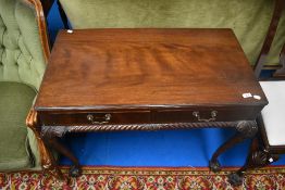 An early 20th Century mahogany hall table having two frieze drawers on cabriole legs having ball and