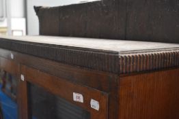A late 19th or early 20th Century oak shallow bookcase with cupboard under