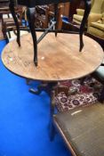 A 19th Century oak pedestal table having turned column and triple splay legs (repair to foot)