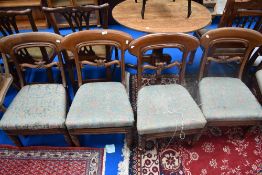 A set of four Victorian mahogany rail back dining chairs having cut down legs