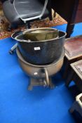 A copper urn , brass coal helmet and enamelled jam pan