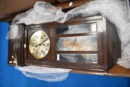 An early 20th century oak cased wall clock.