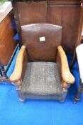 An early 20th Century childs stained frame armchair with leather sides and moquette seat, dimensions