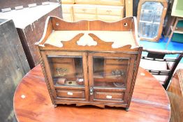 A traditional oak smokers cabinet , having four internal drawers, also including selection of