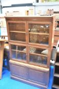 An early 20th Century oak stacking bookcase, having two glazed upper tiers, each with double shelved