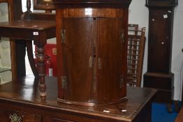A 19th Century mahogany bow fronted corner cupboard of small proportions, height approx. 61cm