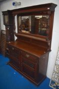 A late 19th / early 20th century mahogany sideboard, having mirrored back, flanked by knopped