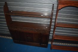 An early to mid 20th Century oak shelf with cupboard under, having open back, width approx. 97cm