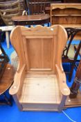 A stripped pine lambing style chair with underseat storage