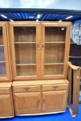 An Ercol lounge display having cupboard base, dimensions approx H162 D43 W91