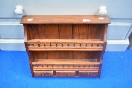 A modern stained frame wall spice rack