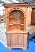 A stripped pine corner shelf with cupboard under , height approx. 200cm